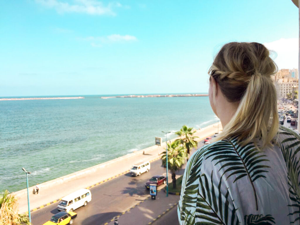 woman looking at the sea and corniche street in alexandria Egypt