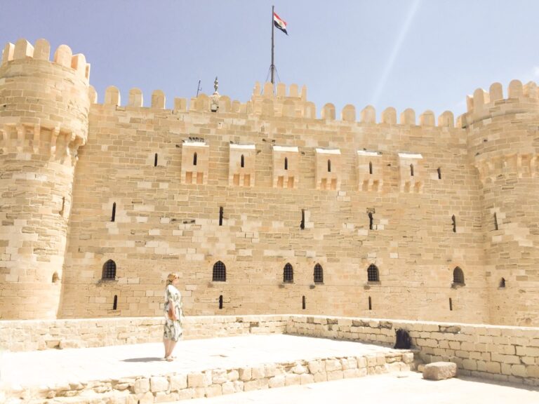 Woman standing in front of Citadel of Qaitbay, Alexandria, Egypt