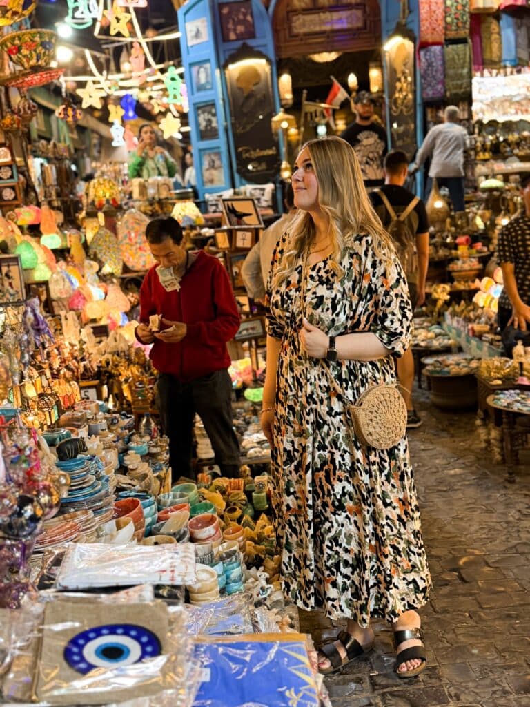 woman standing between lantern shops in khan-el-khalili bazaar cairo egypt