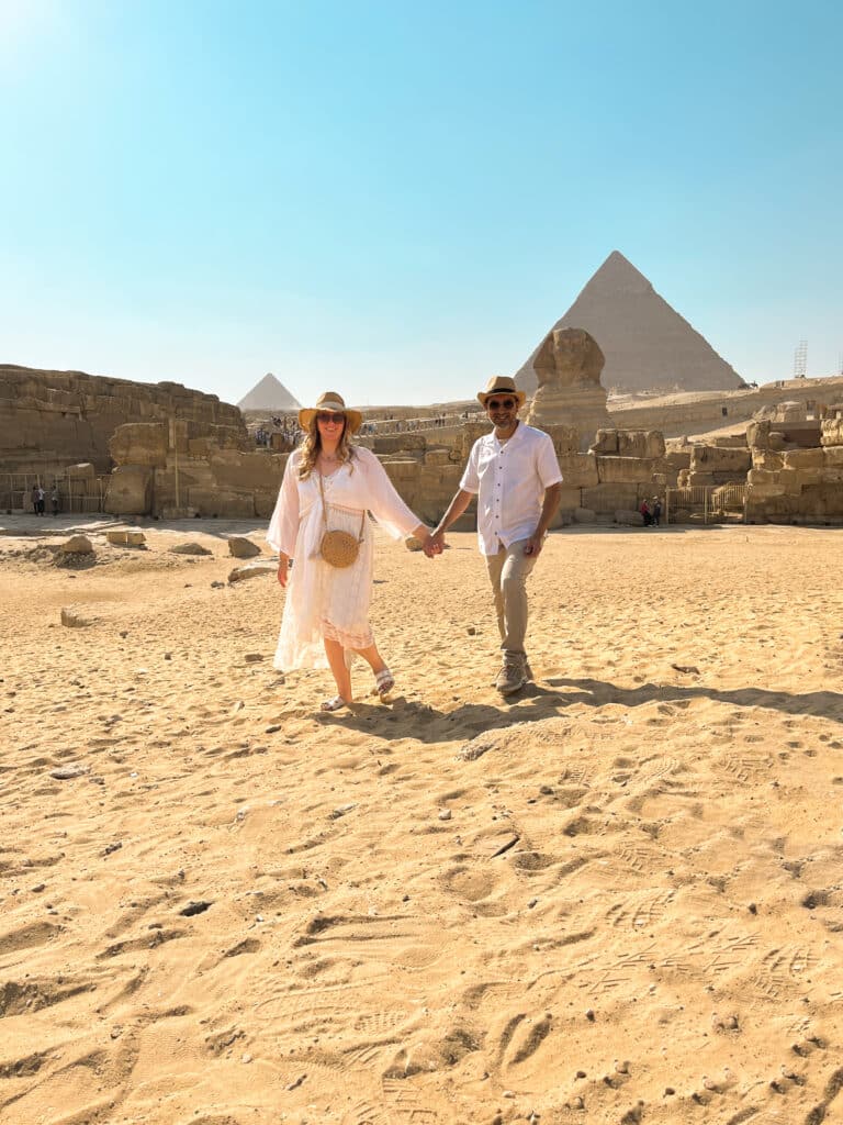 couple in front of sphinx and pyramdids giza egypt